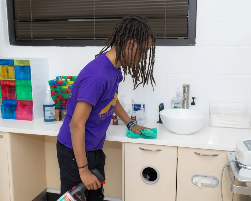 ACS team member wiping counter and sink in a Nashville daycare facility